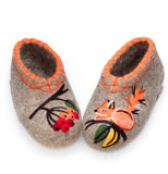  Authentic Slavic heritage wool felt house shoes without thick outsoles, resting on a white background. The light gray felt fabric is decorated with intricate needle-felting art, showcasing a playful ginger fox or squirrel on one toe box and a branch of ripe rowan berries on the other, creating a whimsical and unique look.