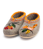 Pair of felted woolen slippers with floral embroidery and a squirrel design on a white background.