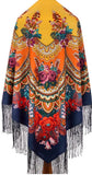 Colorful patterned yellow and blue shawl with floral designs and fringes on a white background. An e-commerce layout showcasing a premium traditional ethnic shawl. The thick, opaque woolen fabric displays a rich variety of colorful vintage flower bouquets in shades of red, pink, and orange, contrasting beautifully with the white background and highlighted by a heavily textured fringe border.