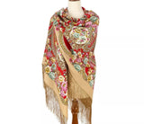 Colorful floral and paisley patterned woolen scarf with fringes on a mannequin against a white background. A macro view of a warm, heavy-weave red woolen shawl sample. The pattern highlights a colorful blend of heritage paisley frames and oversized blooming vintage peonies in contrasting tones of pink, gold, and green foliage.