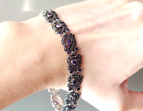 This Armenian Spirit Sterling Silver 925 Bracelet is a luxurious and eye-catching addition to any outfit. Handmade with purple gems, this trendy contemporary piece exudes elegance and is perfect for any evening occasion. Elevate your style with this stunning cocktail purple accessory.