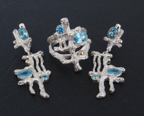 Modern jewelry set with light blue zircons. The jewelry set is contemrorary and modern, made in a art jewelry style. Earrings and ring gold plated silver 925.