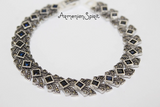 This silver 925 bracelet features vibrant navy topaz stones that exude the beauty and spirit of Armenian culture. Made with high-quality materials, this elegant piece can be customized to any desired length for a perfect fit. Elevate any outfit with this timeless and meaningful accessory.