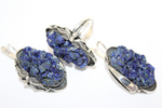 Handmade jewelry silver earrings and ring with bright azzurite gemstone and flowers arround earrings and ring.