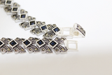 Do not know what present to your beloved wife,? This high quality silver bracelet is a really wanted gift for woman who loves luxury jewelry with shiny marcasite stones. The bracelet is made in chic vintage style and will attract a lot of attention. This is a beautiful and unique bracelet. The stones are square and navy blue lab created topaz stones.