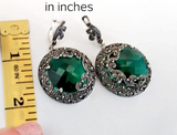 Buy massive earrings round with English lock and emerald green large gemstone.