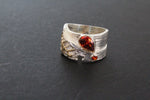 Band ring for woman who loves wide band with modern design and burgundy gems.