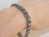 Add a touch of luxury and elegance to your outfit with this stunning Armenian Spirit bracelet. Made with high-quality sterling silver and adorned with marcasite stones, this bracelet is perfect for any cocktail party or special occasion. Elevate your style and make a statement with this unique piece. Perfect for the woman who wants to feel confident and rich.