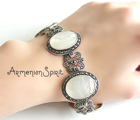 Expertly crafted from high quality sterling silver 925, this vintage bracelet from Etsy shop Armenian Spirit is a must-have for any jewelry collection. Adorned with beautiful nacraous shell beige stones and large gems, it's the perfect retro gift for any occasion. Elevate your style with this timeless and elegant accessory.