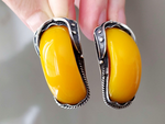 A real find for lovers of large massive jewelry made of precious metals with natural stones! These earrings are made of silver with 925 stamp in the Edwardian style with rough patterns and large oblong Baltic amber yellow gemstones.