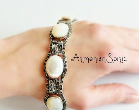 This feminine bracelet features a wide design with a beautiful sadaf gemstone and marcasite detailing. Made from 925 sterling silver, this bracelet is inspired by ancient Armenian style and is available in all lengths. Elevate your style with the Armenian Spirit.