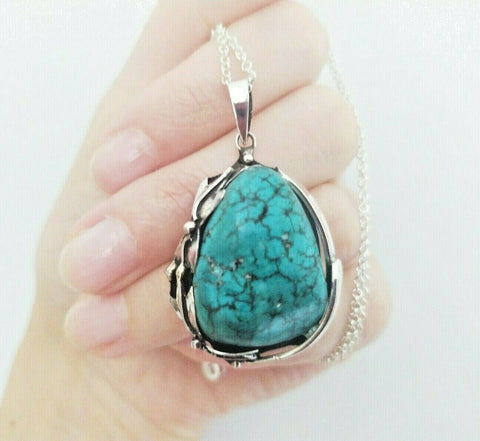 Elevate your style with our handmade Turquoise Pendant Floral Sterling Silver 925 jewelry. This beautiful piece is perfect for any vintage lover and makes a great gift for women. The stunning turquoise color will add a pop of sophistication to any outfit. Get ready to turn heads and stand out from the crowd.