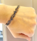 Elevate your style with our stunning bracelet from the Armenian Spirit collection. Made with Sterling silver 925 and adorned with exquisite small flowers, this piece exudes luxury and sophistication. The black onyx gemstones add a touch of richness, making it the perfect gift for yourself or a loved one.