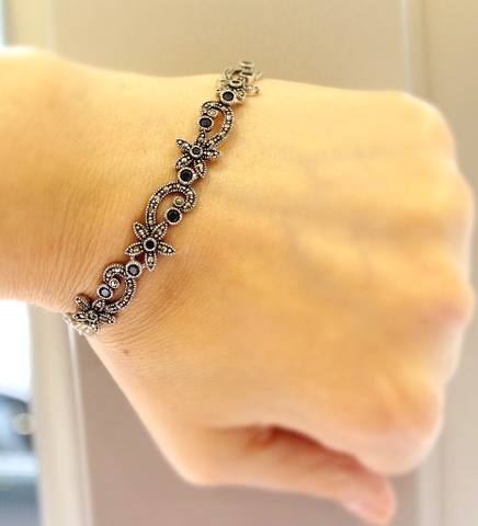 Elevate your style with our stunning bracelet from the Armenian Spirit collection. Made with Sterling silver 925 and adorned with exquisite small flowers, this piece exudes luxury and sophistication. The black onyx gemstones add a touch of richness, making it the perfect gift for yourself or a loved one.