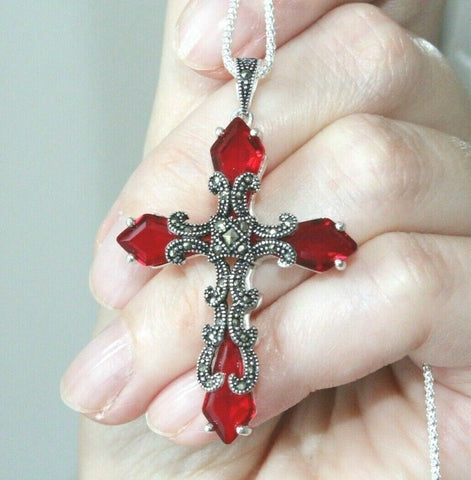 Upgrade your wardrobe with the Cross Silver 925 Marcasite Red topaz Armenian Spirit. This stunning piece features a beautiful red topaz, perfectly matching any red dress. Made with high-quality materials, this accessory will elevate your style and add a touch of elegance to any outfit.