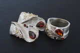 Do you want to buy Armenian contemprorary silver jewelry with dark red gemstones transparent like brililant.The earrings are prolonged approximately 3 cmwith herbal ornament and gold plated parts. The band ring is wide and fashionable with red shiny gem.