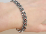 This luxurious silver bracelet is adorned with sparkling marcasite stones, adding elegance and glamour to any outfit. Made with high-quality 925 sterling silver, it is perfect for a rich and sophisticated woman looking to make a statement at a cocktail party or any special occasion. Elevate your style with an Armenian Spirit.