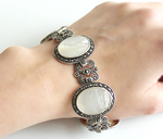 This vintage inspired bracelet is made of sterling silver 925 and oval sadaf creamy gemstones. The patterns of the bracelet remind old style ornaments and the bracelet really looks like vintage and luxury. The closure is a buckle. Find the perfect gift for your loved ones on Etsy! Our top-rated jewelry store offers high-quality pieces at affordable prices. With free worldwide shipping and amazing discounts, it's the best place to buy gifts. 