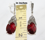 Do not know where to buy marcasite silver earrings in a drop shape with oval wine red gemstone? These earrings has classy design and looks like midevial old fashioned jewellery for wife.