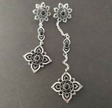 Add a touch of elegance and culture to your outfit with our floral Armenian stud earrings. Made from high-quality silver 925 and featuring a dainty 9 centimeter length chain, these earrings are perfect for any occasion. The intricate black flower design is sure to make a statement and be a unique addition to your jewelry collection.