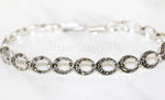 This bracelet is handcrafted with feminine and stylish narrow ovals that showcase the beauty of marcasite stones. Made from high-quality Sterling silver 925, it adds a touch of elegance to any outfit. The perfect piece for those who appreciate unique and intricate designs. All lengths are available..