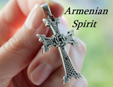 Armenian eight pointed silver body cross pendant with traditional ornaments and 8 points in a woman hand with Armenian Spirit jewelry store title.