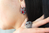 Dome earrings with red stones and matching dome ring on a woman