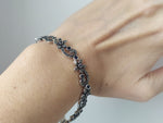 narrow silver bracelet with blue flowers