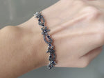 This lightweight bracelet for women is crafted in sterling silver 925 and features delicate blue stones in a small flower design, evoking the elegant and luxurious spirit of Armenian jewelry. Add a touch of elegance with this stylish and feminine bracelet.