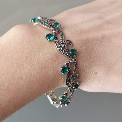 This elegant bracelet, crafted from high-quality sterling silver and marcasite stones, adds a touch of sophistication to any outfit. Available in both long and short lengths, it perfectly complements your feminine and fashionable style, especially when paired with a vibrant green dress. Make a bold statement with this unique and versatile piece of jewelry.