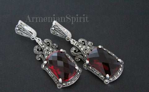 Enhance your jewelry collection with these handmade 925 silver earrings featuring medieval-inspired design and red topaz stones. The intricate craftsmanship and vibrant color add a touch of Armenian spirit to any outfit. These earrings are a unique and elegant addition to any ensemble.