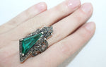 Large ring with emerald green gemstone triangle and bow with marcasites on it. Very large sizes of the ring US size chart