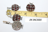 Pomegranate jewelry set near a ruler