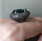 Buy massive dome ring with marcasites and emerald green round gemstone faceted. The ring  has a measurements approximately 5 cm diameter.