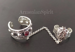 In our store you will find beautiful Bohemian style rings made of sterling silver 925. This ring consists of two rings connected by chains. The upper part of the ring is a pomegranate - the symbol of a family and prosperity in Armenian culture. The bottom ring has&nbsp;a small red artificial garnet stone on it. 